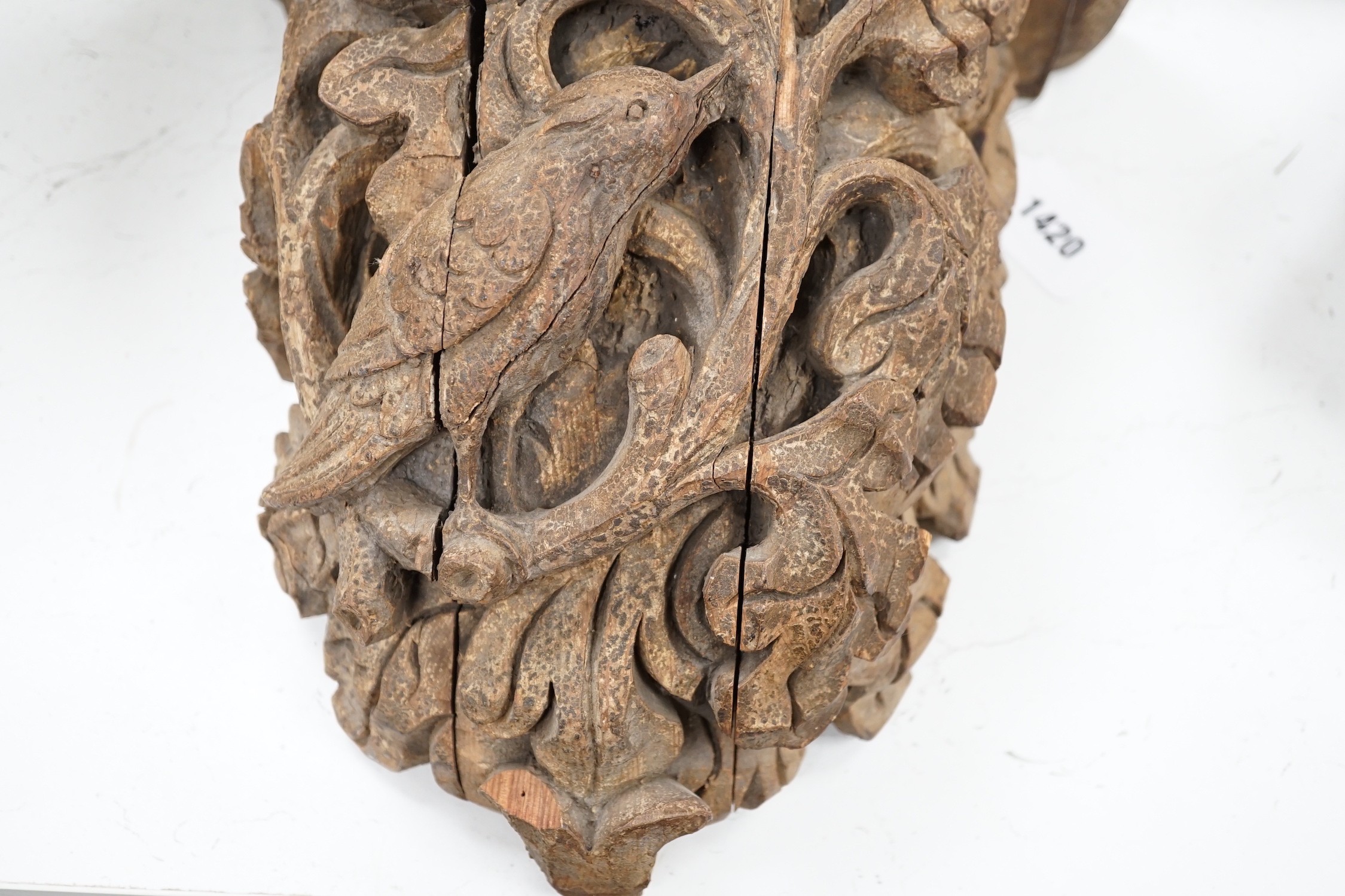 A Victorian/Edwardian carved pine wall bracket, carved with a bird within scrolling oak leaves, 36cms high